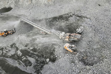 A quarry for the extraction of migmatite and crushed stone, equipment in the quarry.