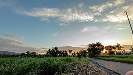 What a beautiful view. The streets weren't crowded in the morning. The sun rose in a beautiful orange hue. The blue sky combined with the orange hues created an extraordinary beauty.