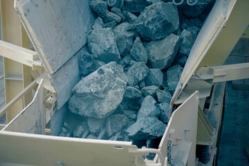 Movement of asbestos rock for grinding to fine fraction