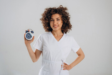 Clock, the time is ticking. Beautiful woman is in the studio