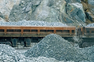 Loading of crushed stone into trolleys on the railway track.