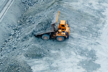 dump truck pours out crushed stone near the railway for subseque