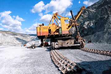 Large mining excavators in parking lot in the quarry.