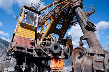 Large mining excavators in parking lot in the quarry.