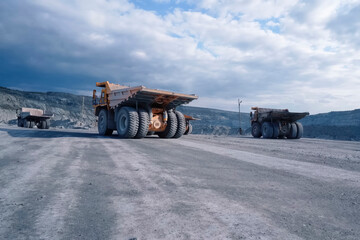 larger mining dump truck in the quarry against the background of
