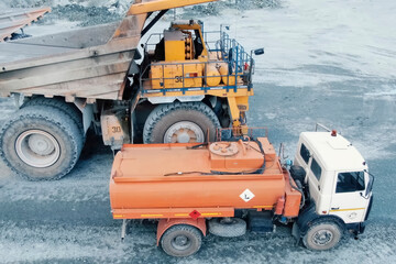 tanker for a mining dump truck refuels it.