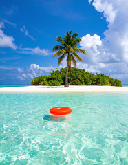 Beautiful remote sandy island with palm tree and floating red inflatable in calm turquoise ocean waters under vibrant sunny blue sky