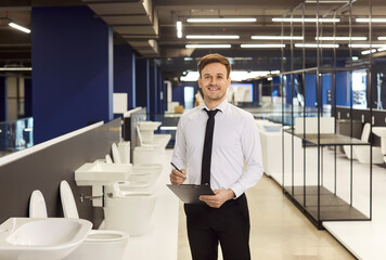 Young smiling experienced plumbing store manager professional corporate portrait, successful worker increasing sales in bathroom, kitchen retail store, building market salesman, consultant at work