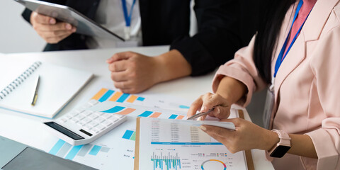 Data Analysis. Professionals reviewing financial documents and charts in a collaborative workspace.