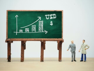 Mini toy of action figure at table with blurred background. Business financial photography concept...