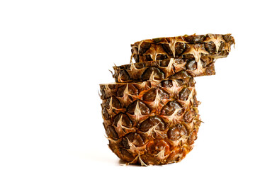 Fresh tropical pineapple, perfectly sliced, with bright yellow juicy flesh on a minimalist white...