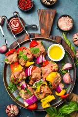 Raw Pork Skewers with Vegetables. Top view. On gray concrete background.