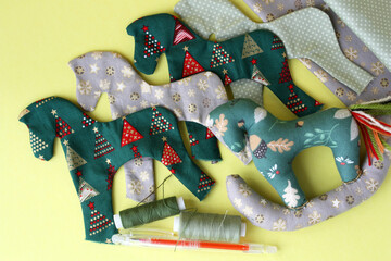 A lot of handmade textile toy in the shape of a small horse. Handmade Tilda toy.