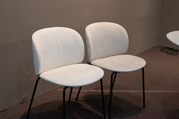 Two white chairs in the room