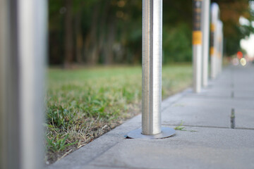 Street poles along modern Warsaw sidewalk in sunny weather