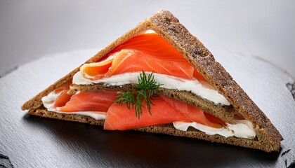 perfectly shaped triangular sandwich with smoked salmon and cream cheese