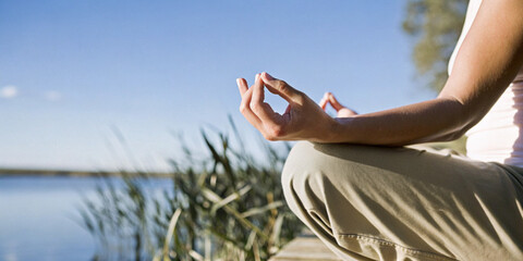 Abstract background. Meditating peacefully by the lake in a mindset of tranquility, along with...