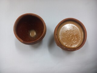 This photo shows a traditional kulhad (clay cup) filled with chai (Indian tea).These clay cups are commonly used to serve hot tea in India, especially at roadside tea shops. Kulhad chai has a distinc