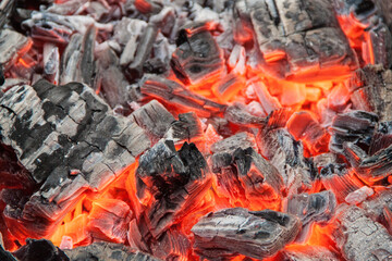 Photo of hot coals. texture of coals on the grill. Edge in the grill