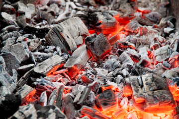 Photo of hot coals. texture of coals on the grill. Edge in the grill