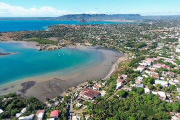 Drone footage of the city of Diego Suarez and the bay - in the background a small conical island off the coast of northern Madagascar