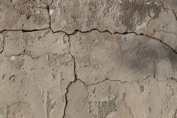 Photo of an old wall. Old wall cracked plaster. Old destroyed wall. Background of old plaster