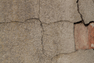 Photo of an old wall. Old wall cracked plaster. Old destroyed wall. Background of old plaster