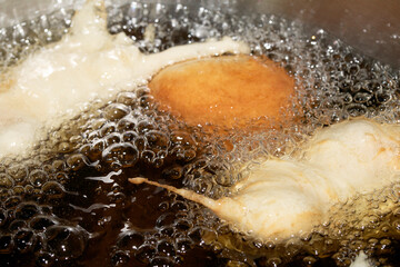 Close up of frying batter in oil chicken balls home made