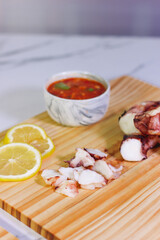 Grilled octopus slices with lemon and dipping sauce
