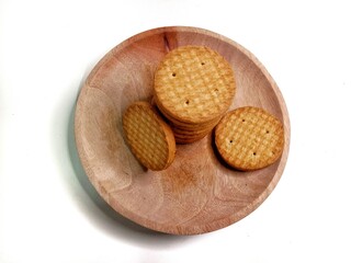 Round crunchy biscuits arranged on a plate, perfect for snack, breakfast, or tea time. Tasty cookies with golden brown texture, ideal for food, bakery, and dessert concepts.