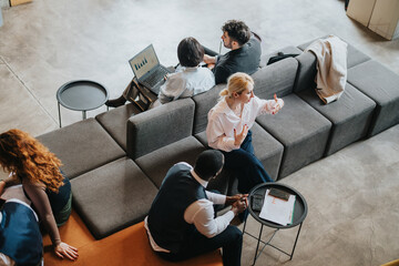 Several people engaging in professional conversations and tasks in a stylish co working environment. They embody teamwork, collaboration, and creative brainstorming in a rustic business atmosphere.