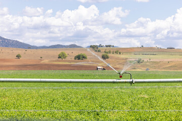 Farm irrigation system watering lush green paddocks in rural NSW