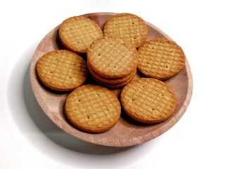 Round crunchy biscuits arranged on a plate, perfect for snack, breakfast, or tea time. Tasty cookies with golden brown texture, ideal for food, bakery, and dessert concepts.