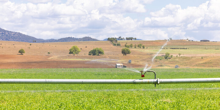 Farm irrigation system watering lush green paddocks in rural NSW