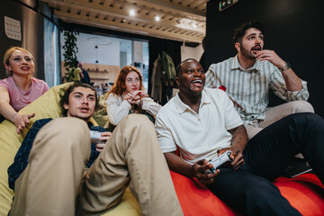 A candid moment of diverse colleagues bonding over a gaming session, showcasing fun, camaraderie, and enthusiasm.