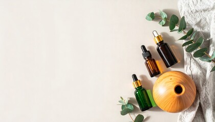 Aromatherapy concept with essential oil bottles, a wood diffuser, and eucalyptus leaves for wellness