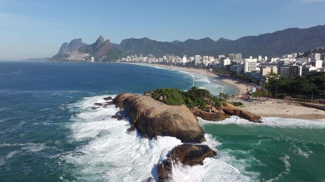 Aerial drone shot of Ipanema Beach and Pedra do Arpoador on a sunny day in Rio de Janeiro, Brazil.	