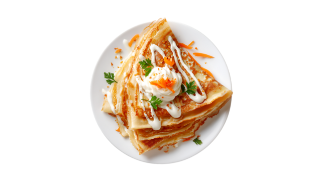 Delicious crepes with creamy sauce and grated carrots on a white plate