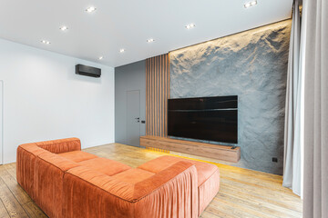 Modern living room design featuring a minimalist layout with textured walls and cozy couch for relaxation