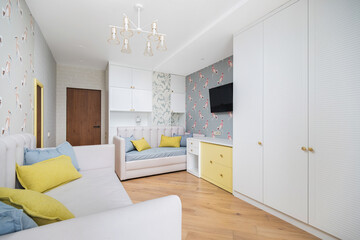 Cozy modern living space featuring a stylish sofa, colorful accents, and elegant decor in an inviting room