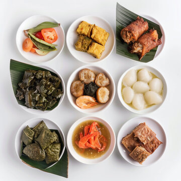 Assorted Papua New Guinean traditional foods mumu, saksak, taro, kaukau, seafood, presented cleanly on separate small white saucers, isolated minimal style