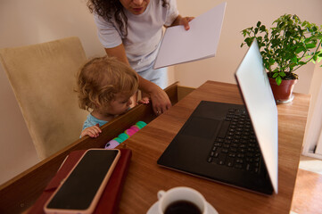 Woman Working from Home with a Child in a Cozy Interior Setting