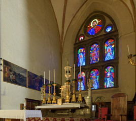 Main altar and stained glass windows inside the Basilica of San Domenico, Siena, Italy, showcasing...