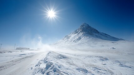 Bright Sun Shines Over Snowy Mountain Landscape During Windy Day