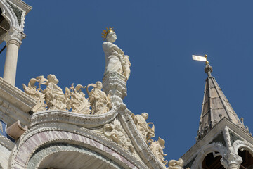Detail of arched marble decoration with porphyry inlays and saints on the facade of St. Mark's...