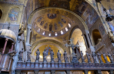 Crucifixion sculpture and apostles in front of Christ Pantocrator mosaic, located in Saint Mark's Basilica, Venice, Italy.