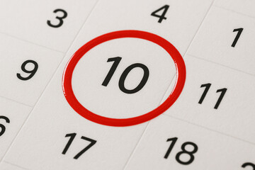 A close-up shot of a calendar highlighting the number 10 in a bright red circle, emphasizing an important date.