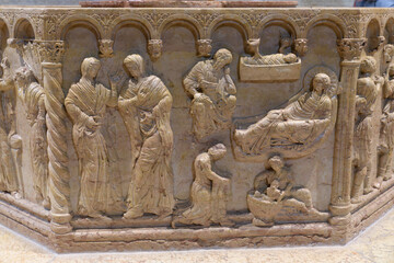 Relief of the Baptism of Christ on the 12th-century octagonal font by Brioloto de Balneo, San...