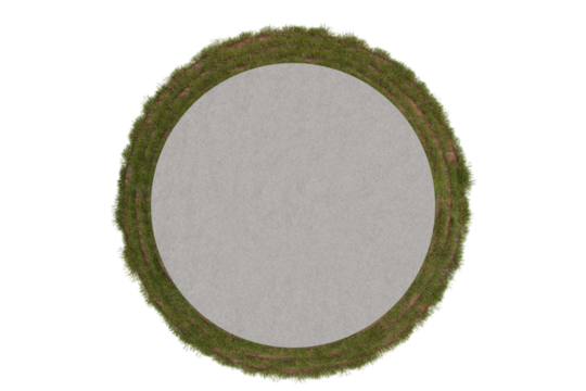 Aerial view of a circular, paved area encircled by a ring of short, green vegetation, possibly grass or weeds. The central area appears smooth and light gray, contrasting with the darker green border.