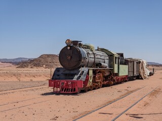 Vintage steam train in the desert landscape, showcasing transportation history and travel...